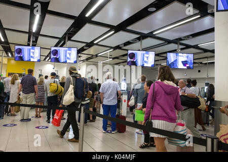 People at the UK border at Gatwick airport waiting to go through the epassport gates to check passport details.The system uses iris recognition. Stock Photo