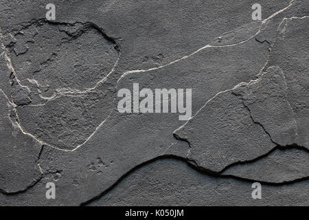 Natural Layered Rough Slate Stone Background Texture in dark grey colour Stock Photo