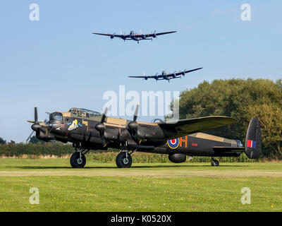 Lancasters 'City of Lincoln' and 'Vera' fly over 'Just Jane' at East Kirkby during the Canadian Lancaster's visit to the UK in 2014. Stock Photo