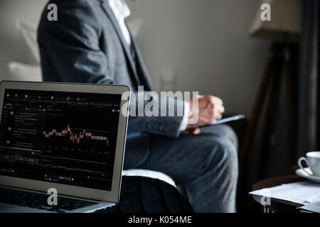 Cropped image of a businessman reviewing some documents and working in a hotel during a business trip Stock Photo