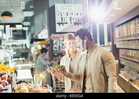 Young couple grocery shopping in market Stock Photo