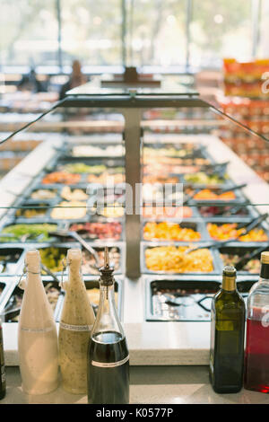 Vinegar and salad dressing on counter at salad bar in grocery store market Stock Photo