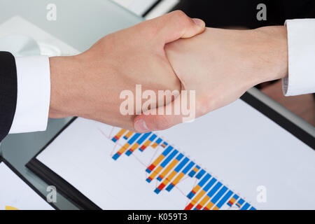 Cropped image of business colleagues shaking hands in office Stock Photo