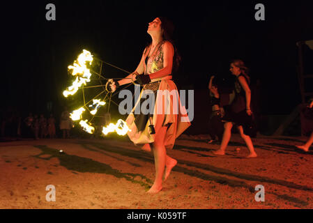 Alburquerque, Spain - august 19, 2017. Female fire show performer at night participing in festival medieval in Alburquerque Stock Photo