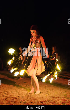 Alburquerque, Spain - august 19, 2017. Female fire show performer at night participing in festival medieval in Alburquerque Stock Photo