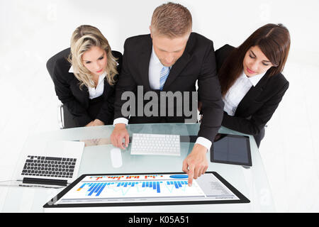 High angle view of businesspeople using desktop PC together at desk in office Stock Photo