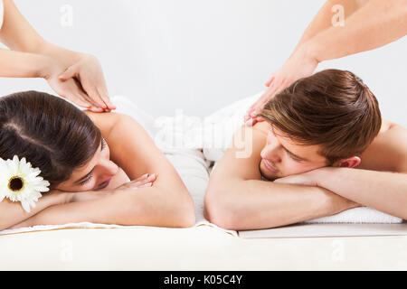 Young couple receiving back massage at beauty spa Stock Photo