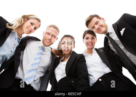 Low angle portrait of business people standing against white background Stock Photo