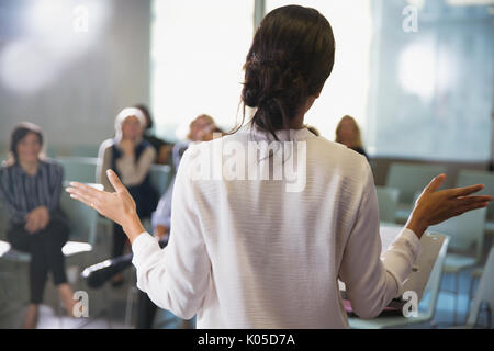 Businesswoman gesturing, leading conference room meeting Stock Photo