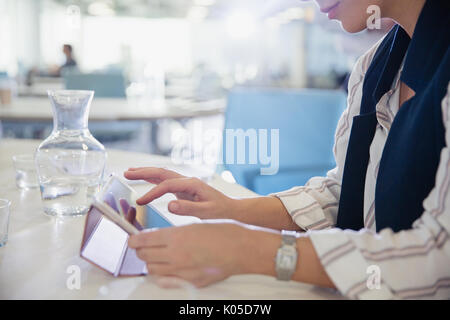 Businesswoman using digital tablet in office Stock Photo