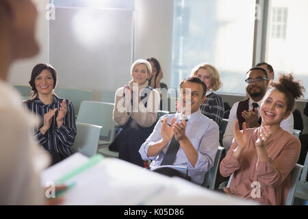 Business people in audience clapping for conference speaker Stock Photo