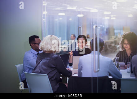 Business people at laptops in conference room meeting Stock Photo