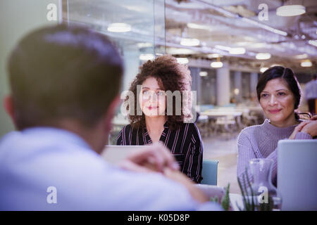 Businesswomen listening in conference room meeting Stock Photo