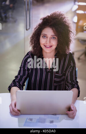 Portrait smiling, confident businesswoman working at laptop Stock Photo