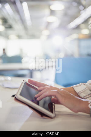 Close up hands of businesswoman using digital tablet in office Stock Photo