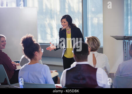 Businesswoman gesturing, leading conference presentation Stock Photo