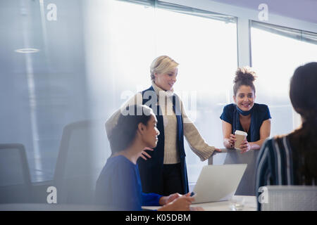 Businesswomen talking, working in conference room meeting Stock Photo