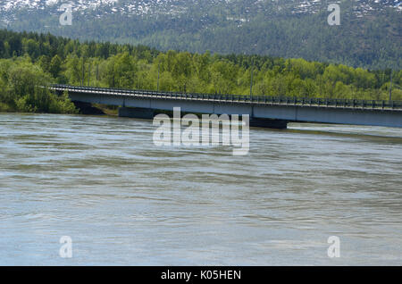 flooded river in spring underneath bridge Stock Photo
