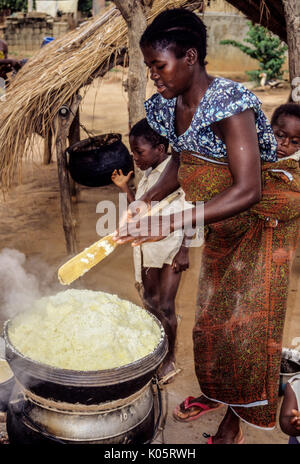 Bamoro, Cote d'Ivoire (Ivory Coast).  Village Woman Preparing Atieke, a Starchy Staple Made from Cassava. Stock Photo