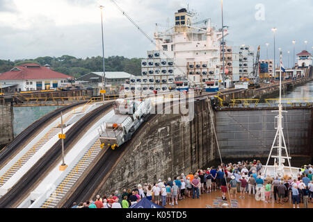 Panama Canal, Panama.  Entering First Lock, Caribbean Side, Heading toward Lake Gatun.  'Mule' Locomotive Pulling Ship Forward into the Lock While Pas Stock Photo