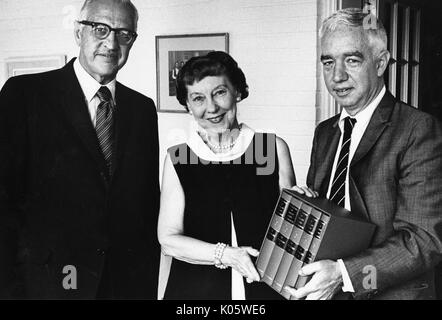 Half-length portrait of Dr Alfred D Chandler presenting Mamie Eisenhower, former First Lady of the United States and wife of former United States President Dwight Eisenhower, with a set of her husband's World War II correspondence, Mamie wearing a dark dress and the two other men wearing dark suits, smiling facial expressions, 1973. Stock Photo