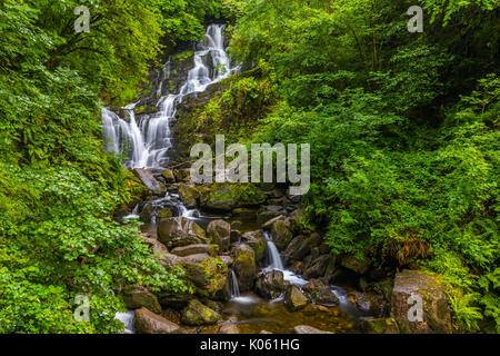 Torc Waterfall is a waterfall at the base of Torc Mountain, about 8.0 km from Killarney in County Kerry, Ireland Stock Photo