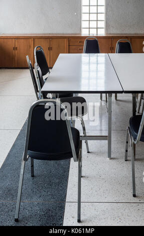 Large table and metal chair set for informal conference in the morning before the office hour outside the office building. Stock Photo