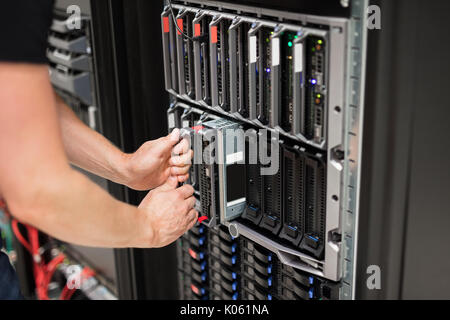 Computer Engineer Installing Blade Server In Data Center Stock Photo