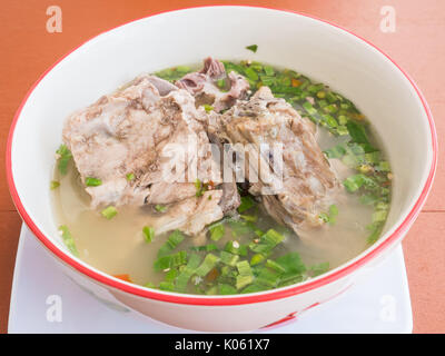 Boiled pork spine with the chilli and lime in the traditional Thai style.famous street food in Thailand. Stock Photo