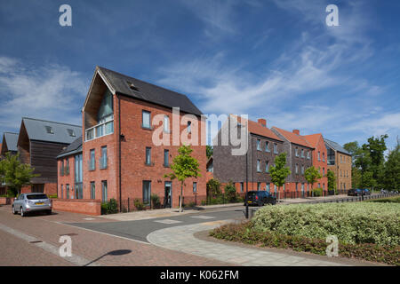 Contemporary Eco-designed modern suburban housing development with trees lining street at Upton, South West District, Northampton, England. Stock Photo