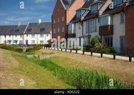 Mixed housing styles are to be found within the contemporary suburban development with a sustainable drainage system, Upton in Northampton, England. Stock Photo