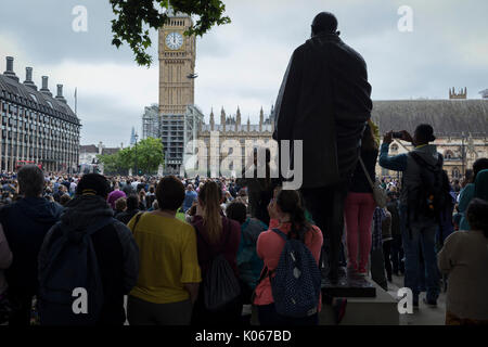 London, UK 21st August 2017: Crowds gather by the statue of Mahatma Gandhi in Parliament Square to hear the last chimes of Big Ben, the giant bell in Elizabeth Tower that rings across London, before its controversial silencing, except for special occasions, by the repair project that is scheduled to be completed by 2021. Photo by Richard Baker / Alamy Live News. Stock Photo