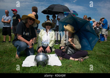 Amherst, USA. 21st Aug, 2017. Three women using colander to view eclipse in Amherst, MA Credit: Edgar Izzy/Alamy Live News Stock Photo