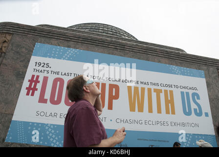 Chicago, Illinois, USA. 21st Aug, 2017. On August 21, 2017, the solar eclipse mesmerized people across the U.S. as the moon passed between the sun and earth. In Chicago, thousands headed toward the Adler Planetarium by car, by bus or by walking. The Museum handed out 35,000 pairs of special eclipse glasses so that individuals could safely experience this once in a lifetime phenomenon. The lakefront by the Planetarium also has one of the best views of the Chicago skyline. At 1:19 PM, the coverage reached its peak in Chicago- not quite reaching totality, but still quite impressive. (Cred Stock Photo
