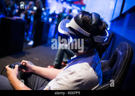 Cologne, Germany. 22nd Aug, 2017. A gamer tries out a computer game at the Gamescom in Cologne, Germany, 22 August 2017. The gaming expo runs through to the 16 August. This year's expo is to be officially opened by the German chancellor Angela Merkel. Photo: Oliver Berg/dpa/Alamy Live News Stock Photo