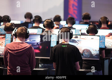 Cologne, Germany. 22nd Aug, 2017. Gamers try out computer games at the Gamescom in Cologne, Germany, 22 August 2017. The gaming expo runs through to the 16 August. This year's expo is to be officially opened by the German chancellor Angela Merkel. Photo: Oliver Berg/dpa/Alamy Live News Stock Photo