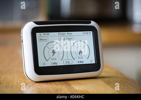 Smart Meter on a Kitchen Worktop Displaying Current Electricity and Gas Usage Stock Photo