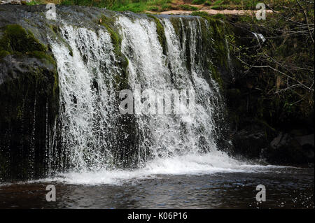 The upper of the two small waterfalls on the Afon Caerfanell near its confluence with the Nant Bwrefwr. Stock Photo