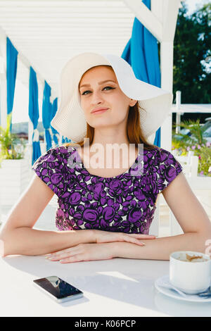 Content woman posing on resort terrace Stock Photo