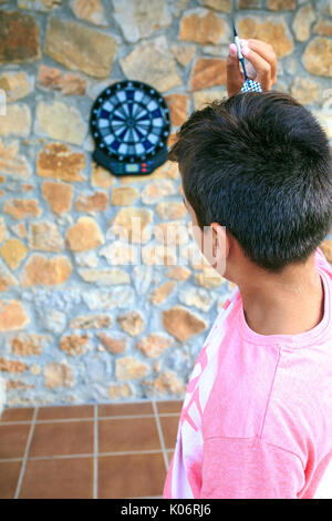 Bullseye on a wall with some darts Stock Photo