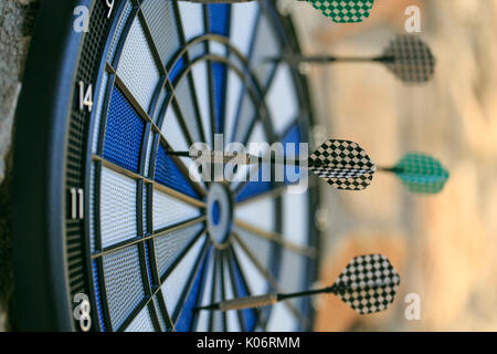 Bullseye on a wall with some darts Stock Photo