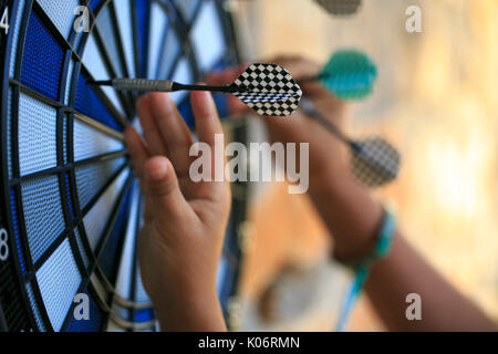Bullseye on a wall with some darts Stock Photo