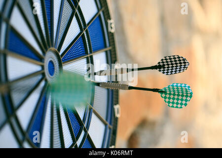 Bullseye on a wall with some darts Stock Photo
