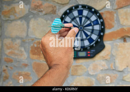 Bullseye on a wall with some darts Stock Photo