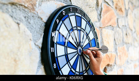 Bullseye on a wall with some darts Stock Photo