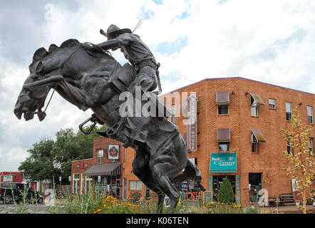 A sculpture called Bronco Buster is in a roundabout on Main Street in Stillwater Oklahoma. Stock Photo