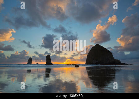 Sunset over Haystack Rock and Cannon Beach along the Oregon Coast. USA Stock Photo