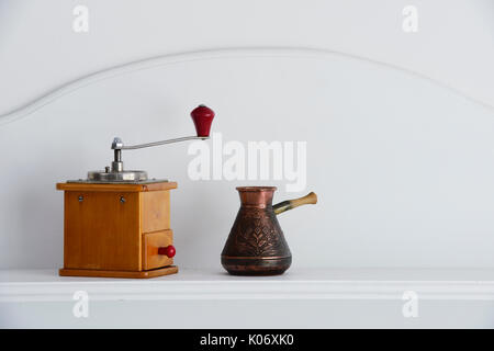 vintage hand coffee grinder and old arabic coffee pot  on a neutral background Stock Photo