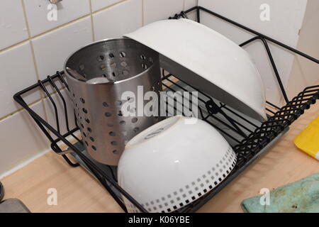 Wet dishes drying on a drying rack Stock Photo
