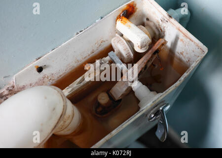 Inside a very old rusty toilet cistern. Stock Photo